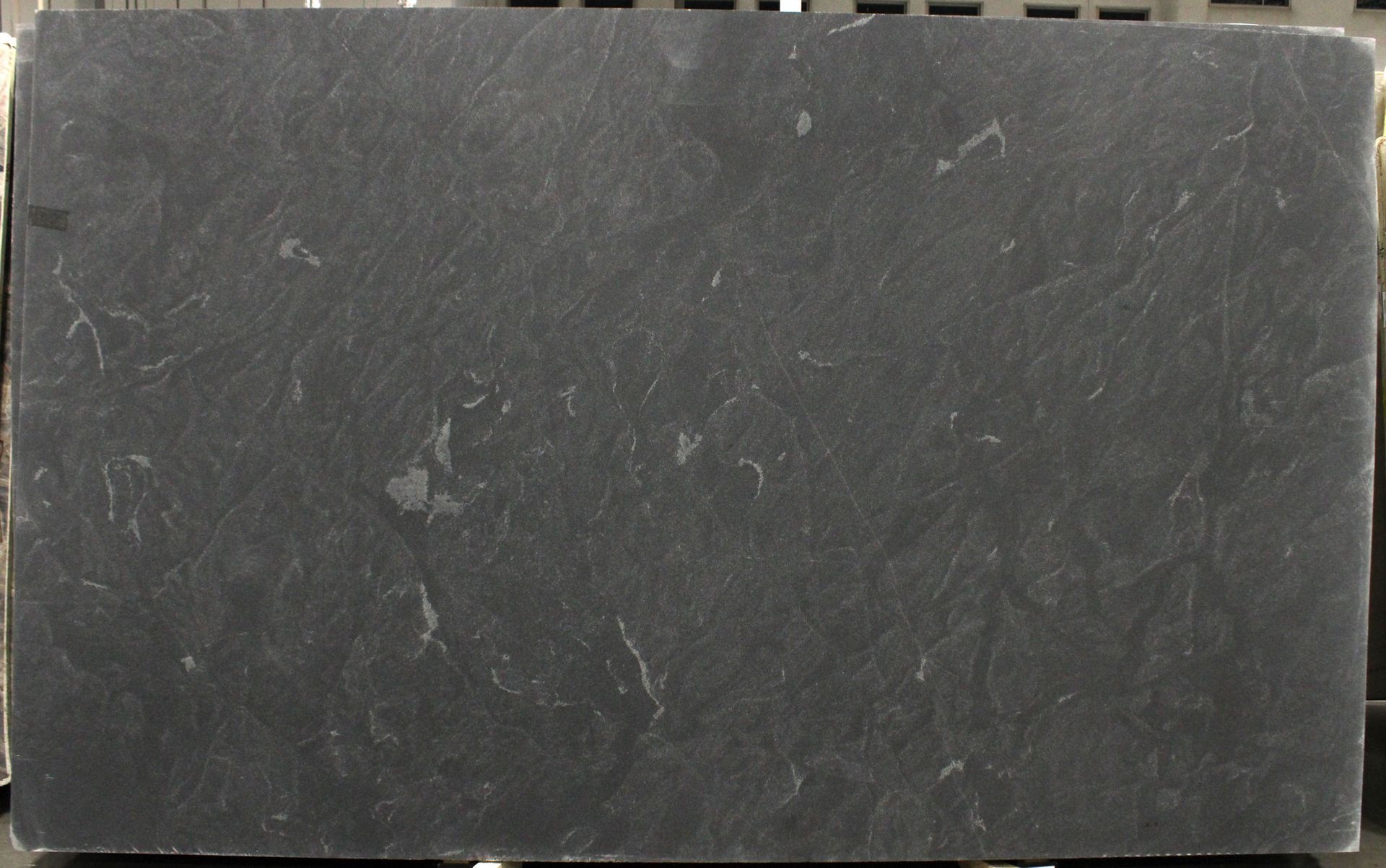 Dark gray rectangular slate stone with light gray veining.