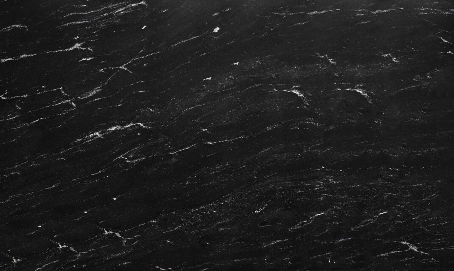 Black marble surface with white veining.