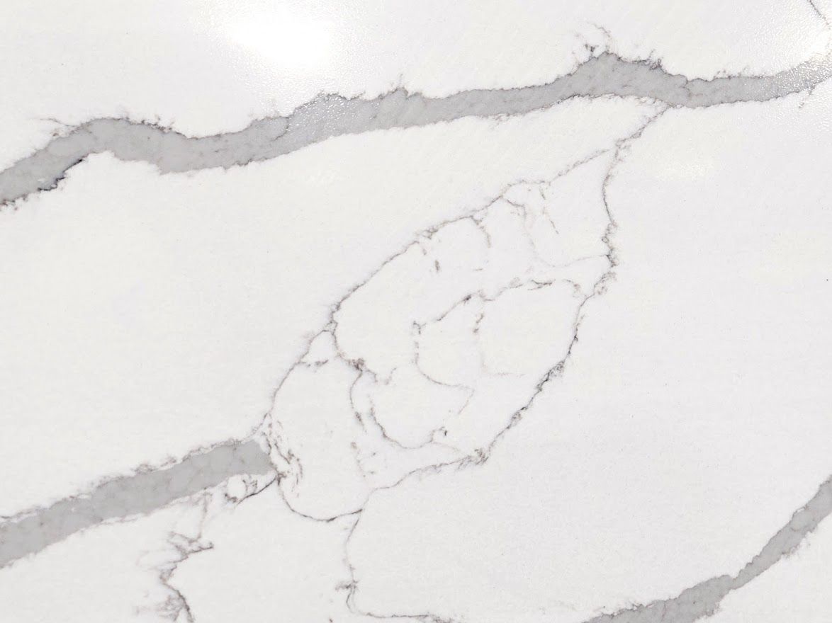 White countertop with grey veining pattern.