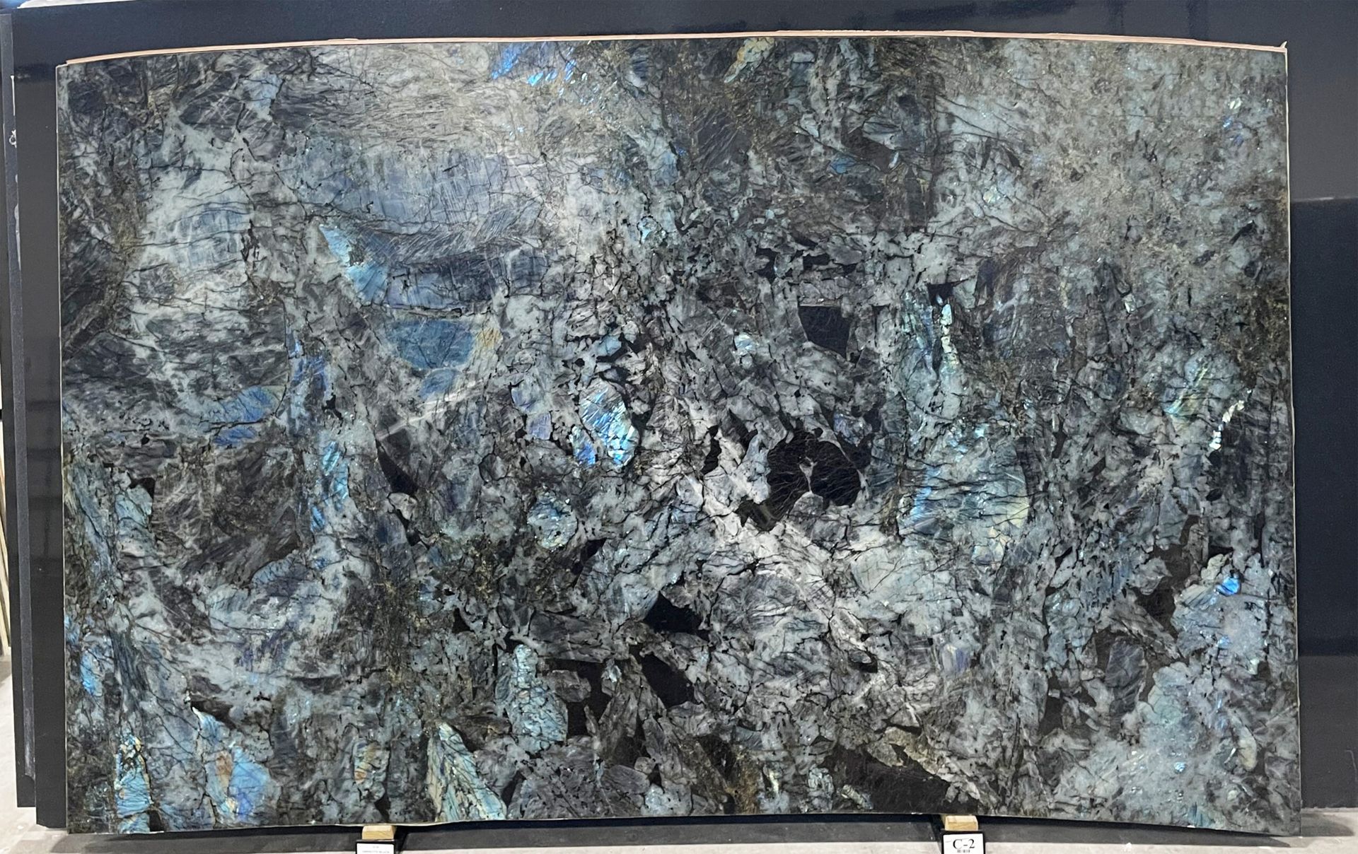 Large slab of granite with dark grey, black, and blue patterns.