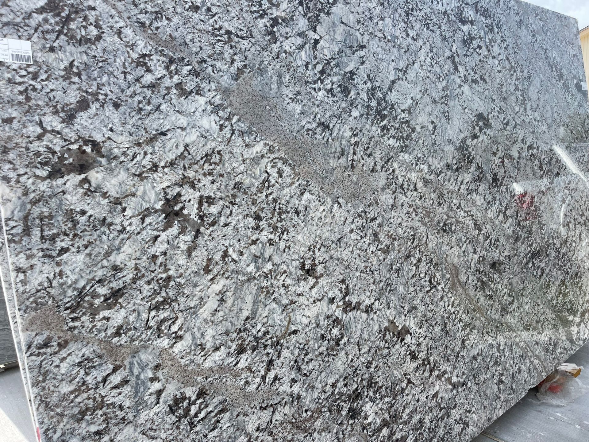 Gray granite slab with speckled pattern, suitable for countertops.