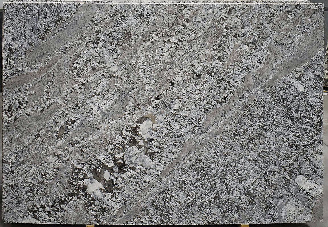 Granite slab, mottled gray with diagonal veins of darker gray and white speckles.