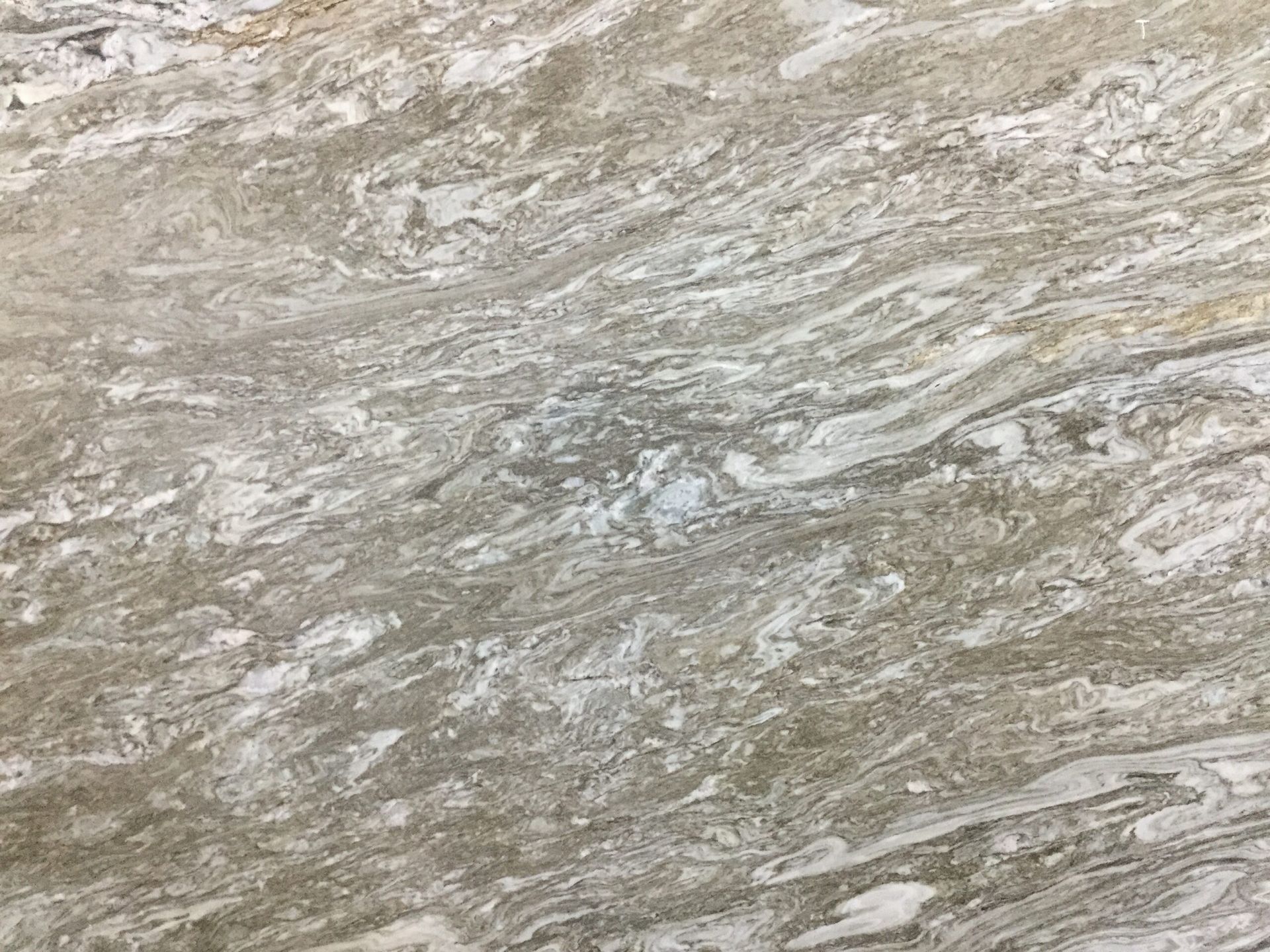 Swirling gray, white, and tan stone surface with a marbled appearance.