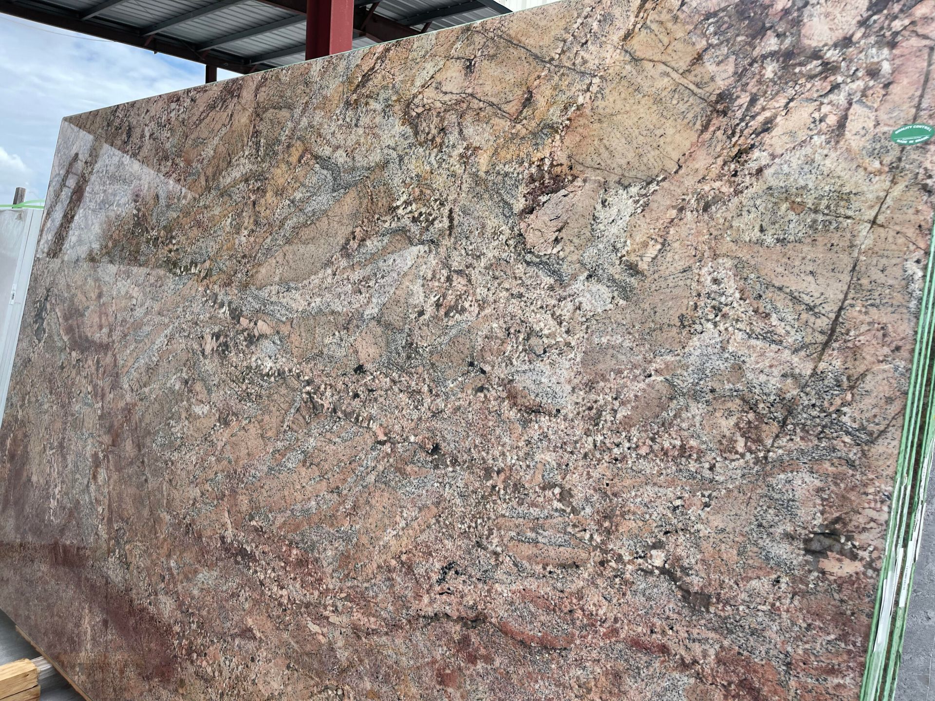 Large slab of granite with tan, brown, and black veining, likely for countertop use.