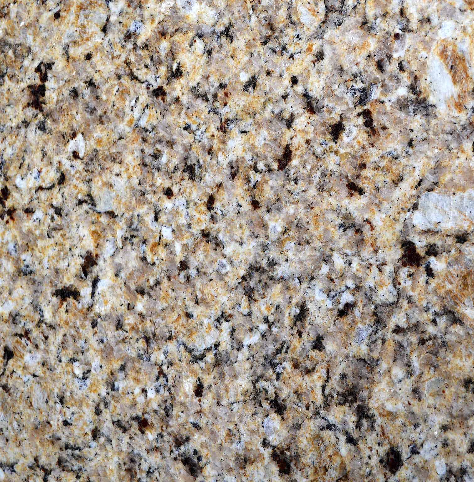 Close-up of granite with beige, brown, and black specks and swirls.