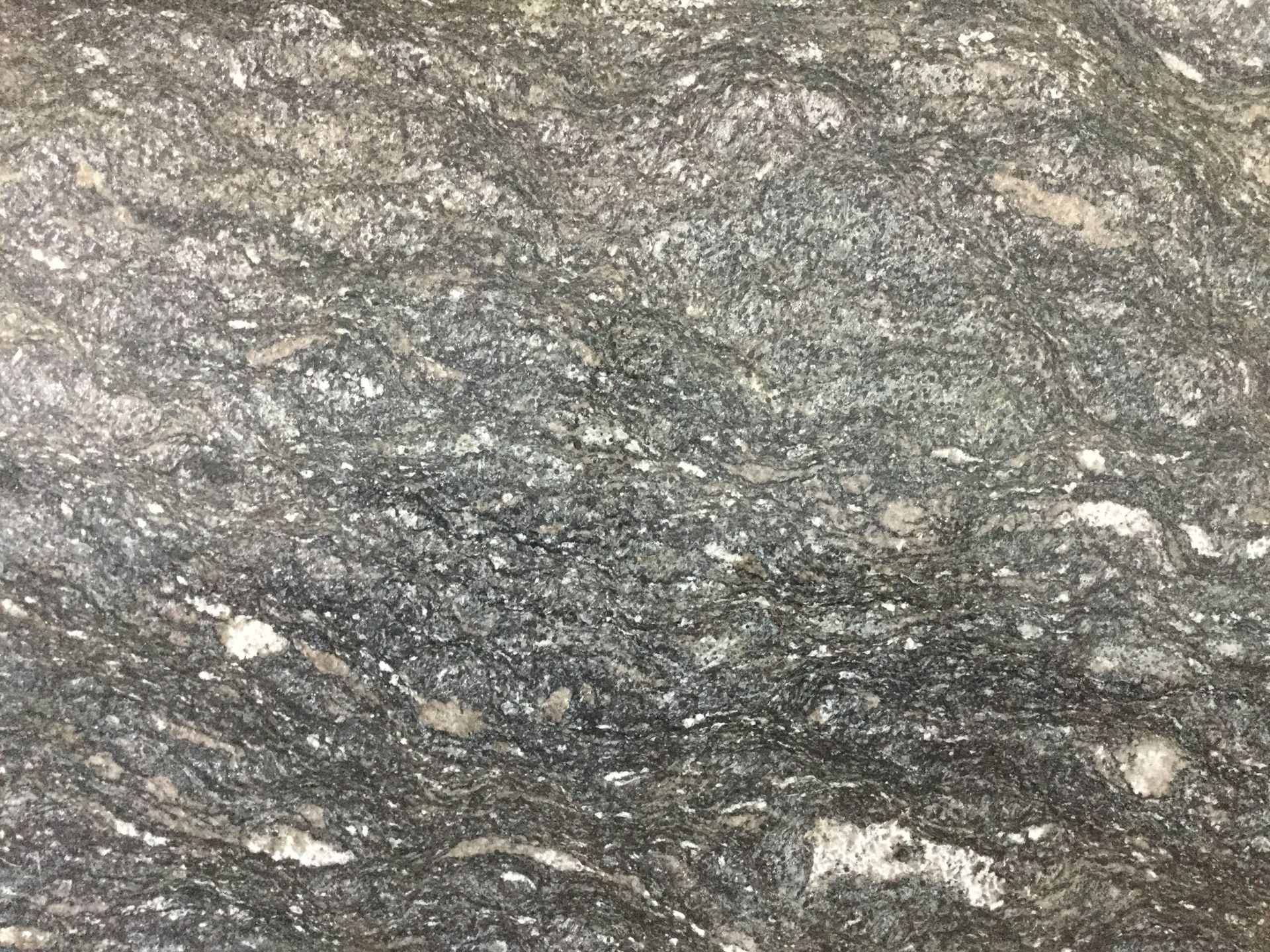 Gray and white swirled stone surface with varying textures.