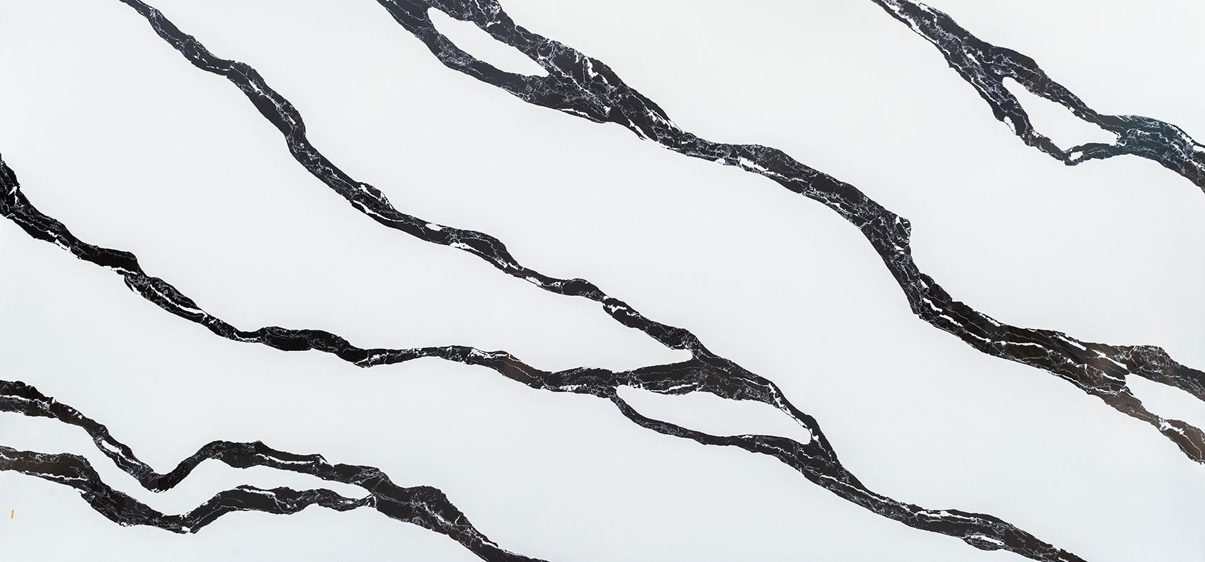 White surface with dark gray, wave-like veining, mimicking the look of marble.
