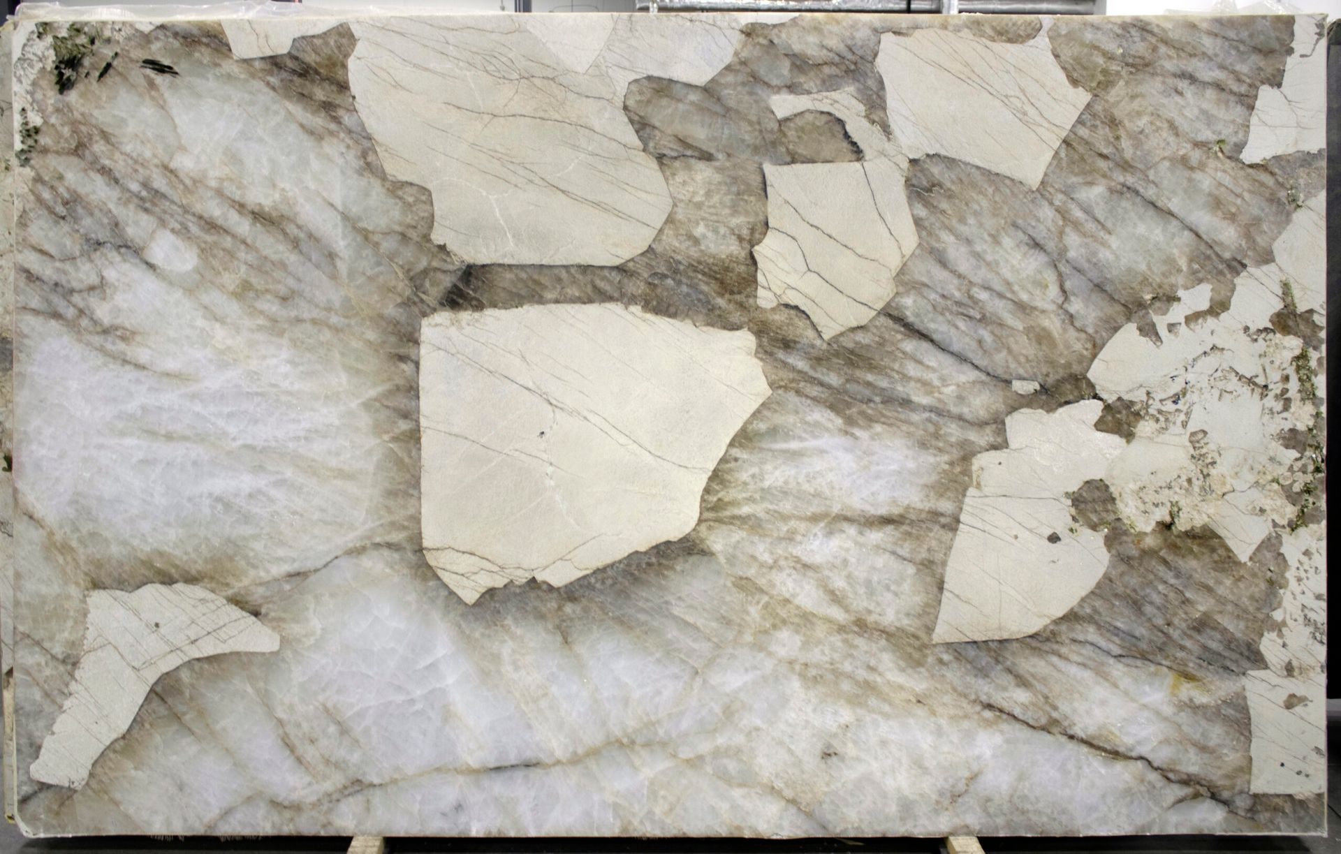 Large slab of granite with white, gray, and brown veining and patches.