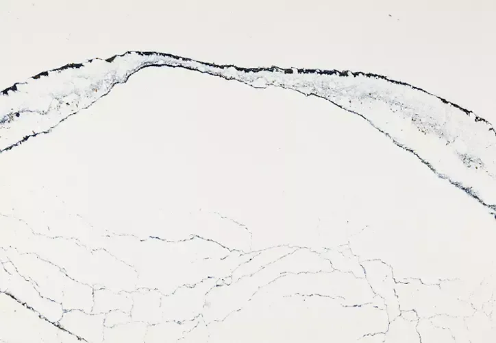 White countertop with dark blue veining and markings.