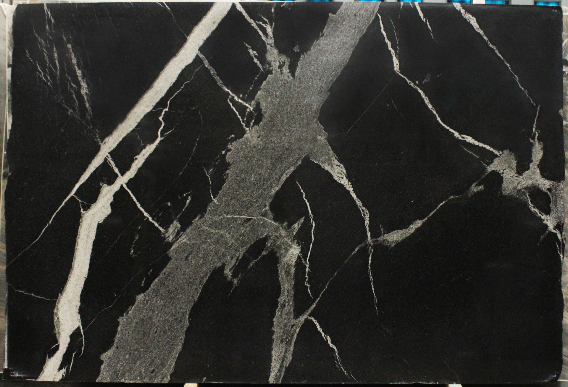 Black marble slab with prominent white and gray veining.