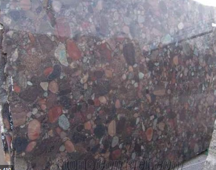 Brown and red speckled granite countertop with various colored stones embedded.