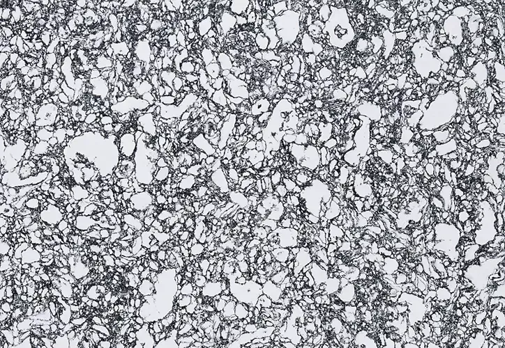 Microscopic view of a metal structure with dark lines outlining irregularly shaped grains, with white spaces in between.