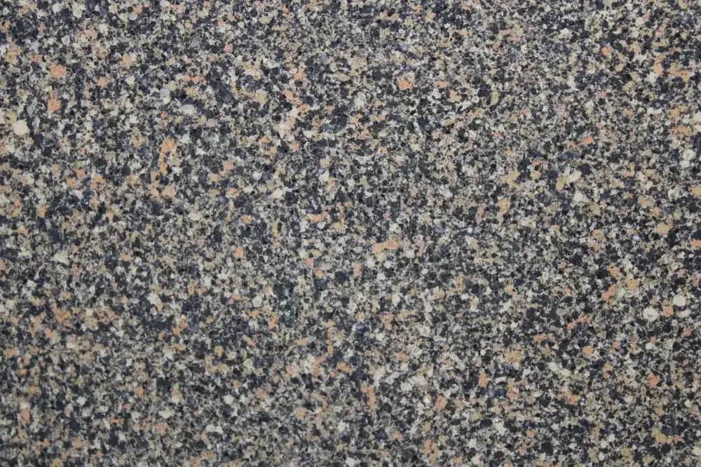 Granite countertop with a speckled pattern of black, tan, and cream colors.