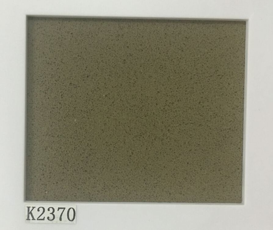 A rectangular sample of olive green quartz countertop with fine speckles, labeled 