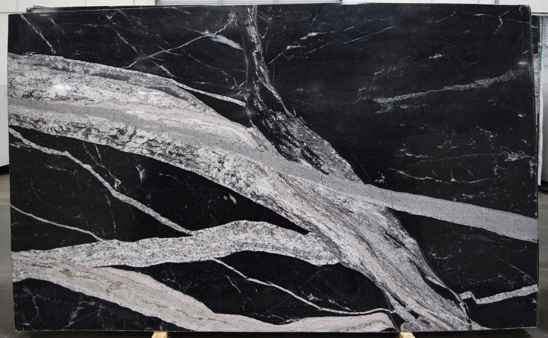 Black granite slab with striking white and gray veining.