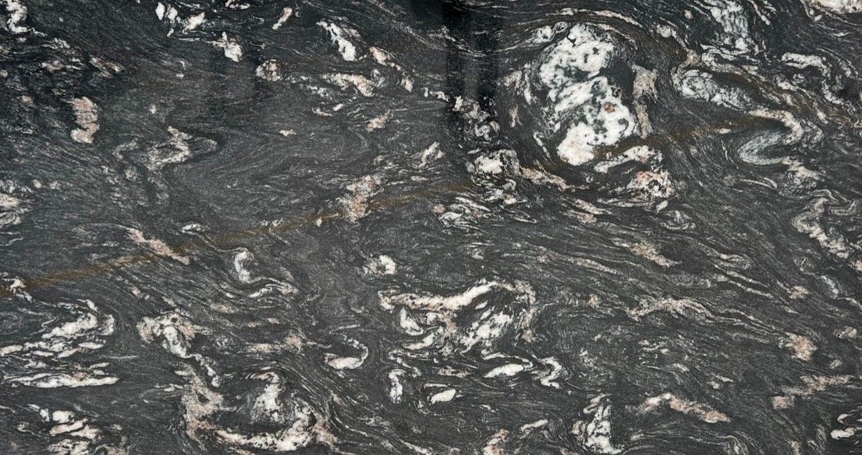 Dark gray granite with swirling patterns and white and silver streaks.