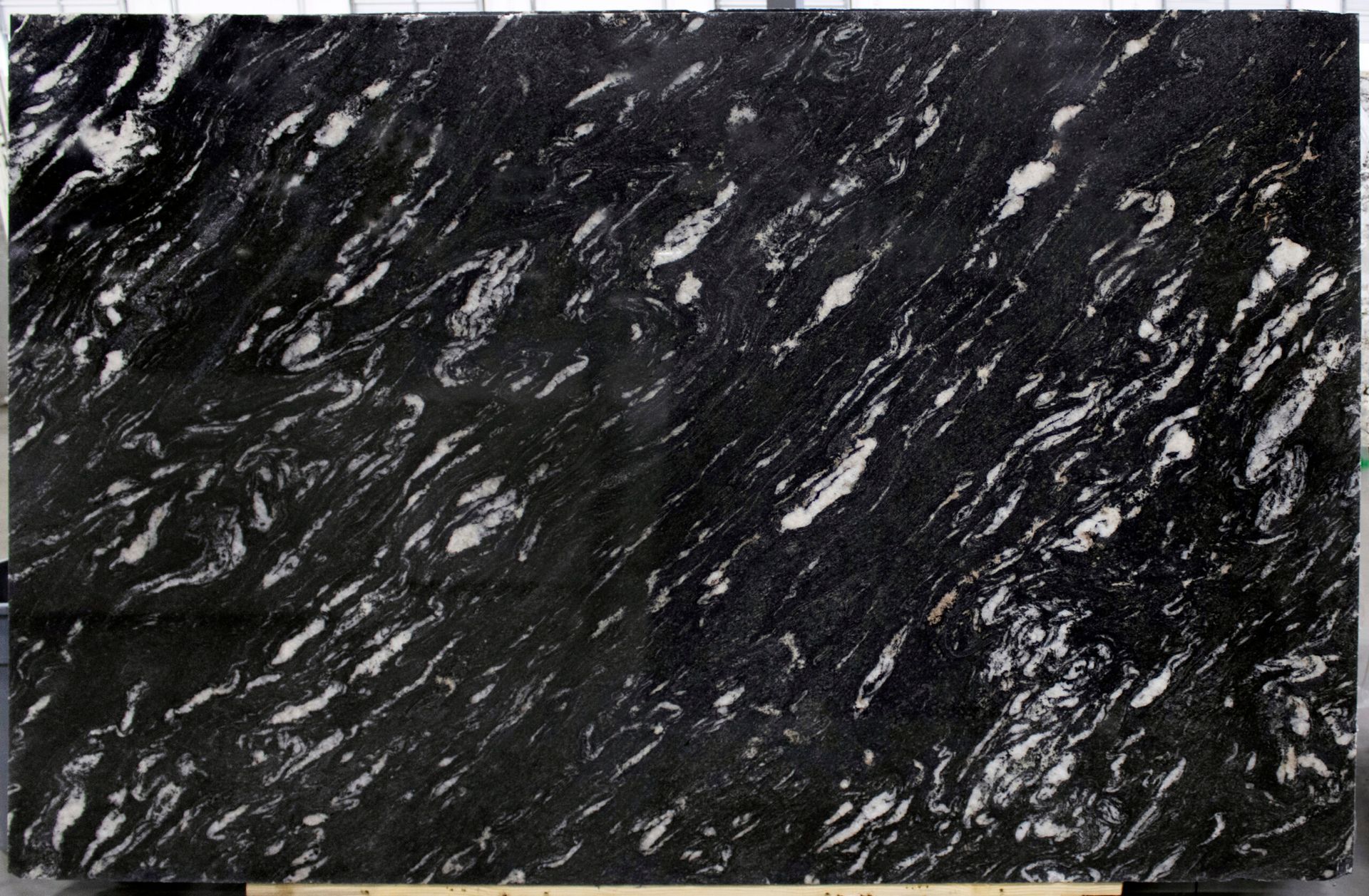 Black granite slab with white streaks and patterns.