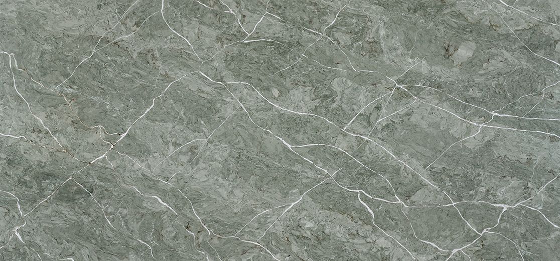 Gray-green textured surface with white veining and cracks, resembling stone or ice.