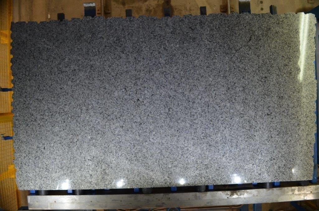 Large, rectangular slab of gray granite. Surface has a textured, speckled appearance.