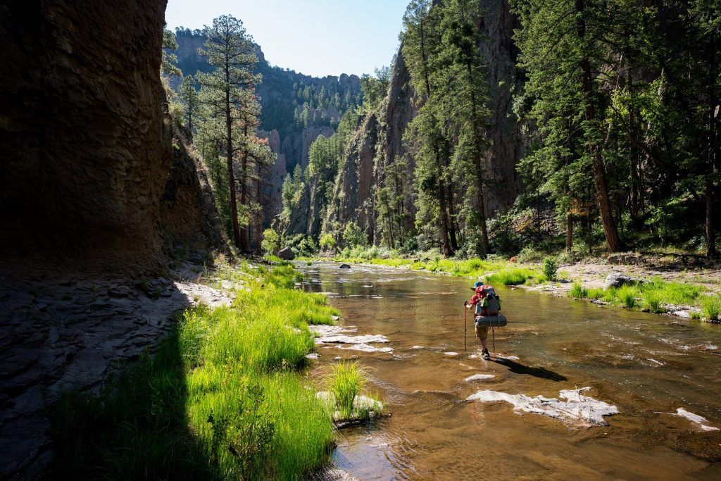 Hiker exploring National Conservation Lands on a clear summer day, highlighting public land access and outdoor recreation.