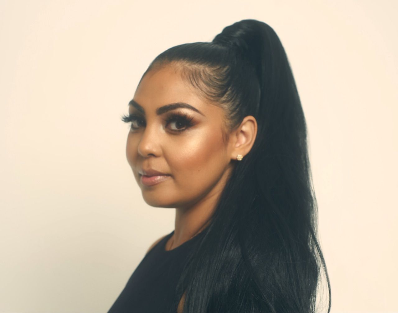 A woman with long black hair in a ponytail