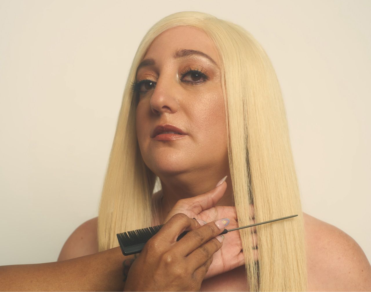 A woman with blonde hair is getting her hair cut