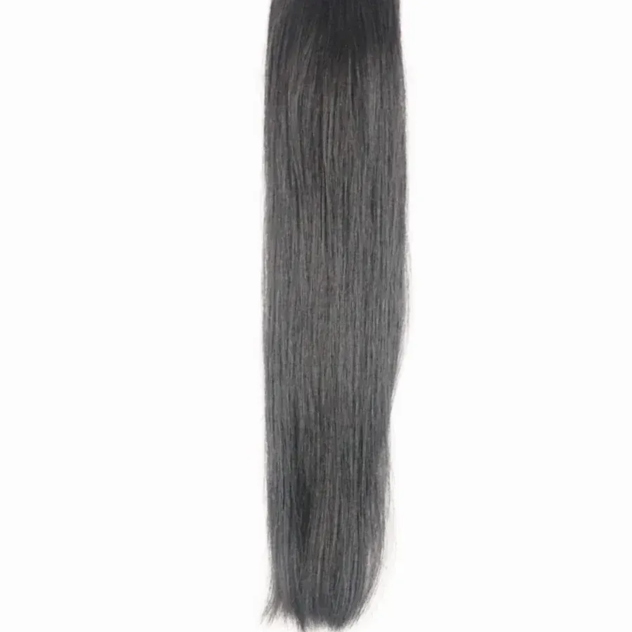 A close up of a piece of black hair on a white background.