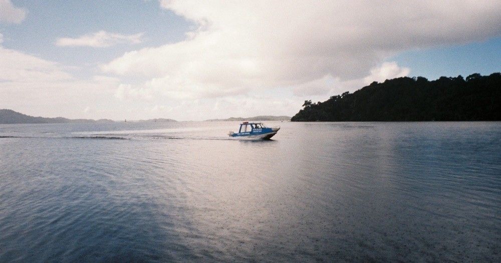 A boat is floating on top of a large body of water.