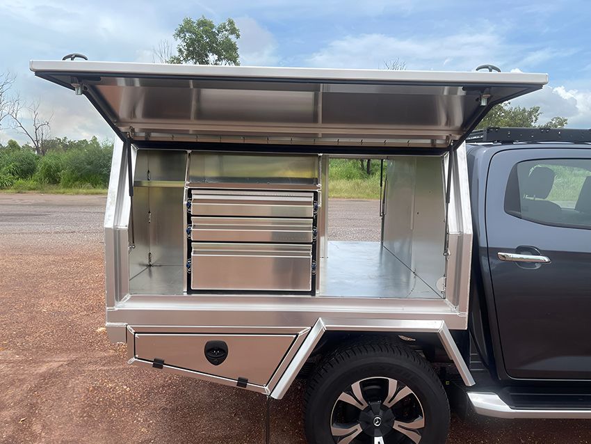 A black truck with a stainless steel canopy is parked on the side of the road. — Allycraft Modifications in Berrimah, NT