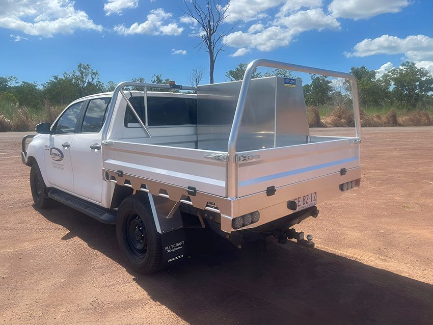 A White Truck with a Tray on the Back is Parked on a Dirt Road — Allycraft Modifications in Berrimah, NT