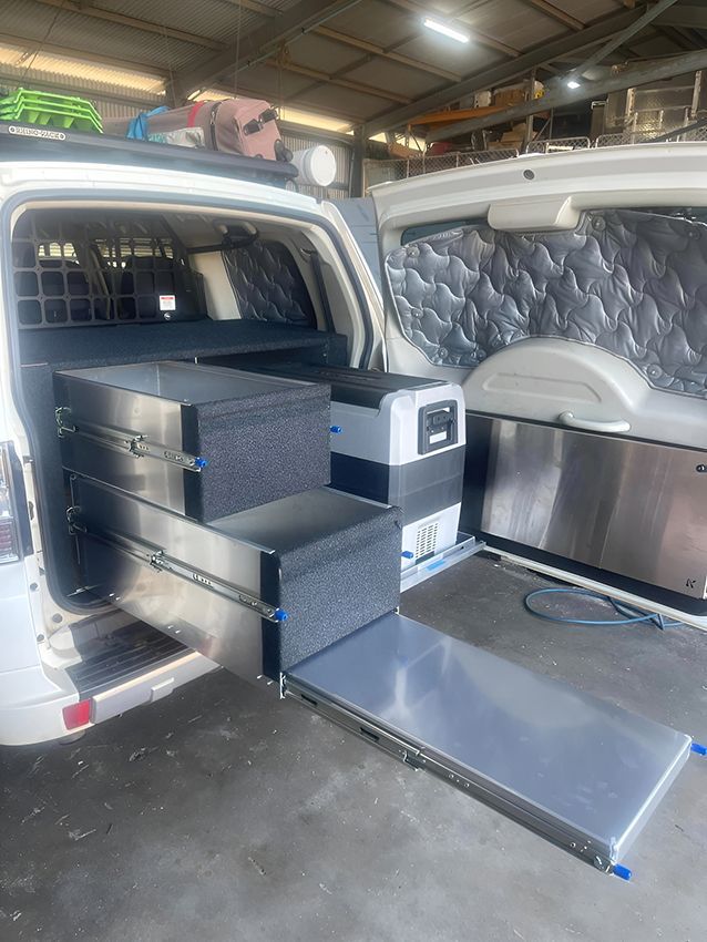 A white suv with stainless steel drawers and a fridge in the back. — Allycraft Modifications in Berrimah, NT