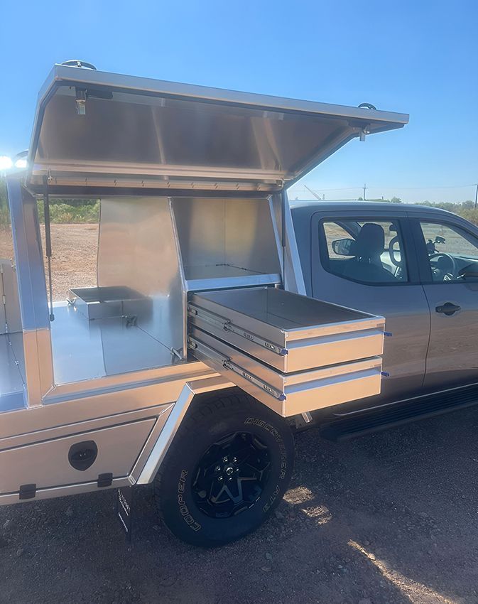 A truck with a canopy and drawers in the back is parked in a parking lot. — Allycraft Modifications in Berrimah, NT