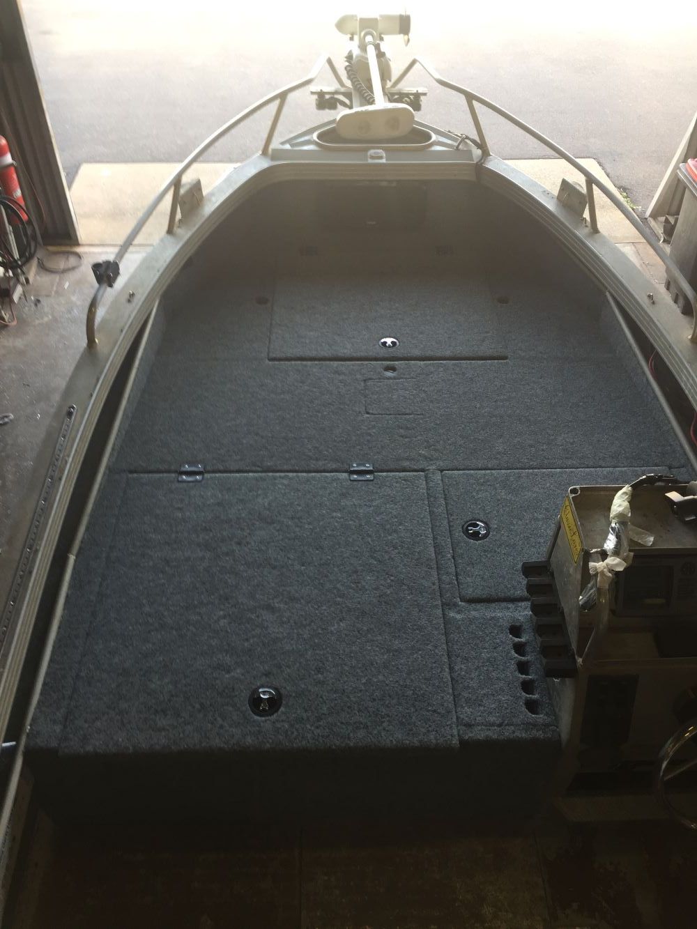 A Boat is Sitting in a Garage With a Motor Attached to It — Allycraft Modifications in Berrimah, NT