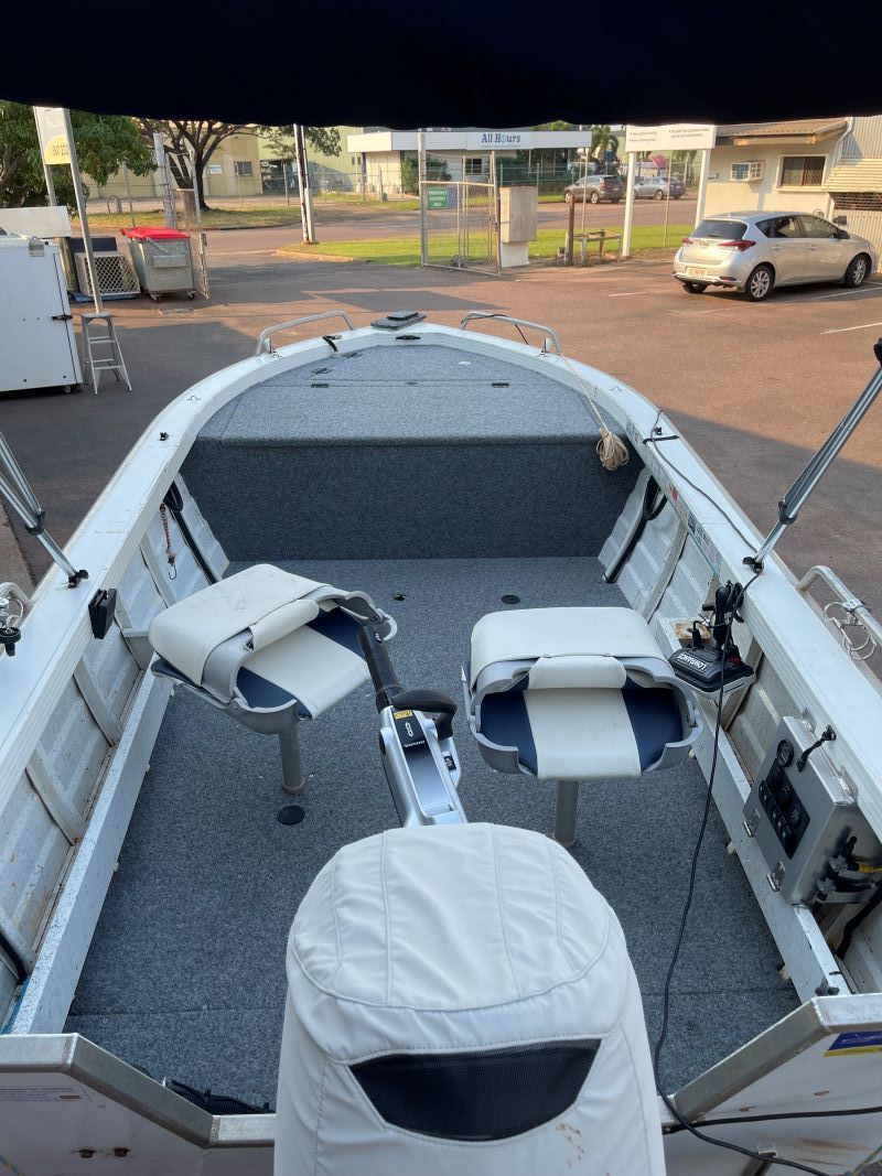 A White Boat is Parked in a Parking Lot Next to a Car — Allycraft Modifications in Berrimah, NT