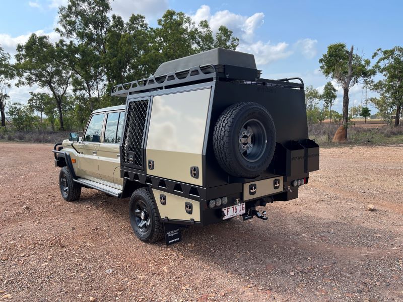 A Truck With a Canopy on Top of It is Parked in a Dirt Field — Allycraft Modifications in Berrimah, NT