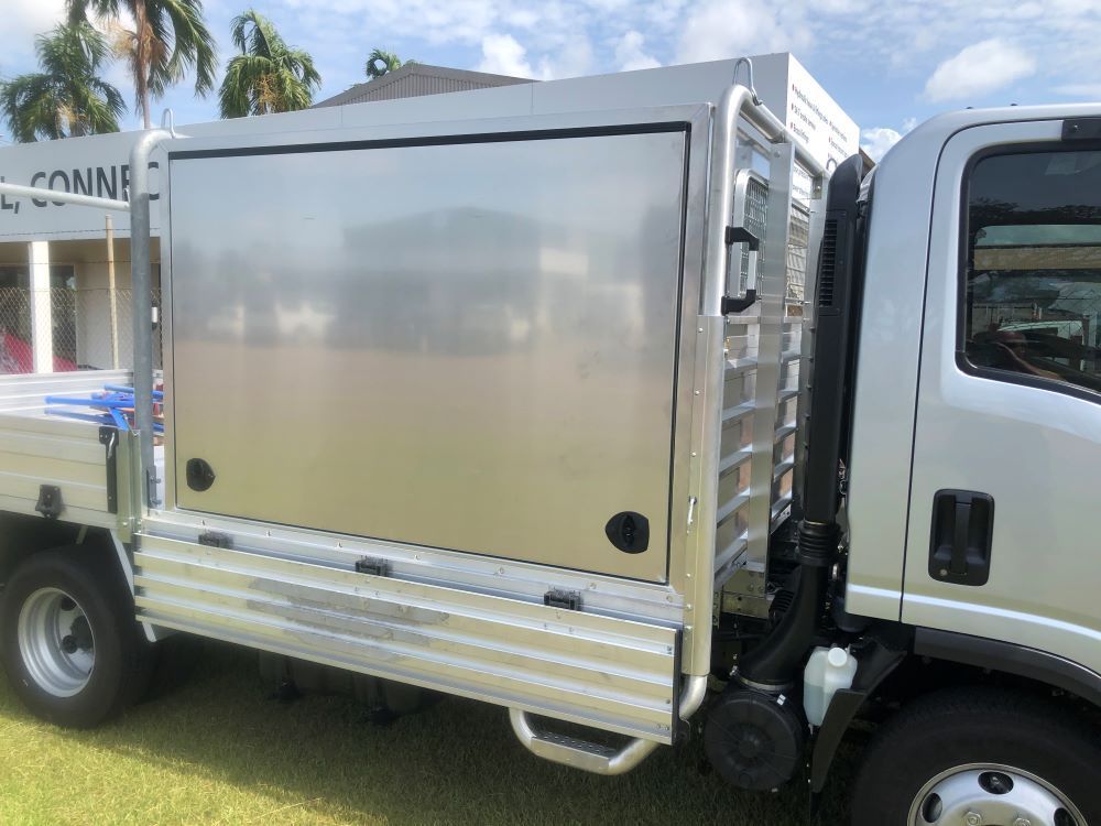 A Silver Truck With a Stainless Steel Box on the Back is Parked on the Grass — Allycraft Modifications in Berrimah, NT