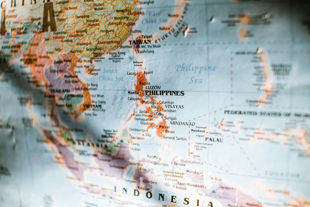 A close-up, angled view of a colorful world map centered on the Philippines, Southeast Asia, and Indonesia.