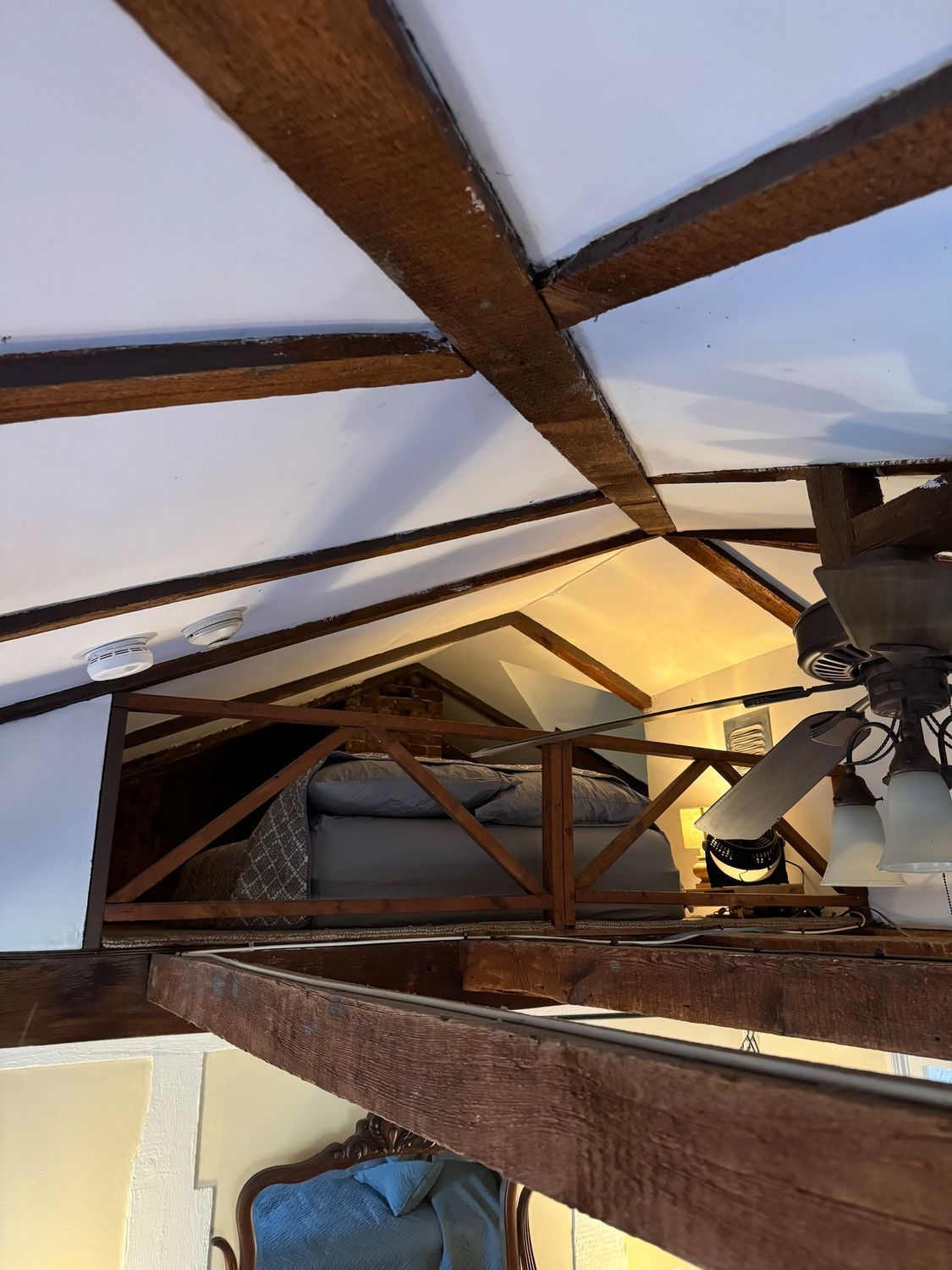 A living room with a ceiling fan and a couch.