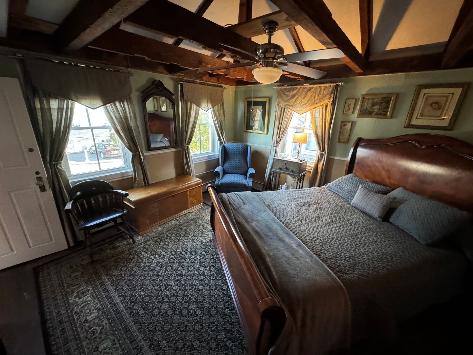 A bedroom with a king size bed and a chair