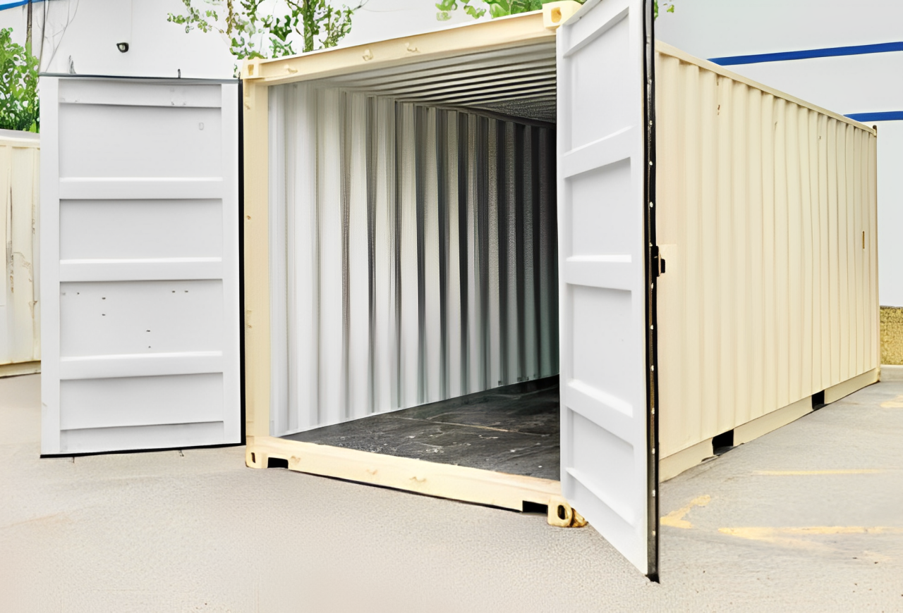 A shipping container with its doors open in a parking lot.
