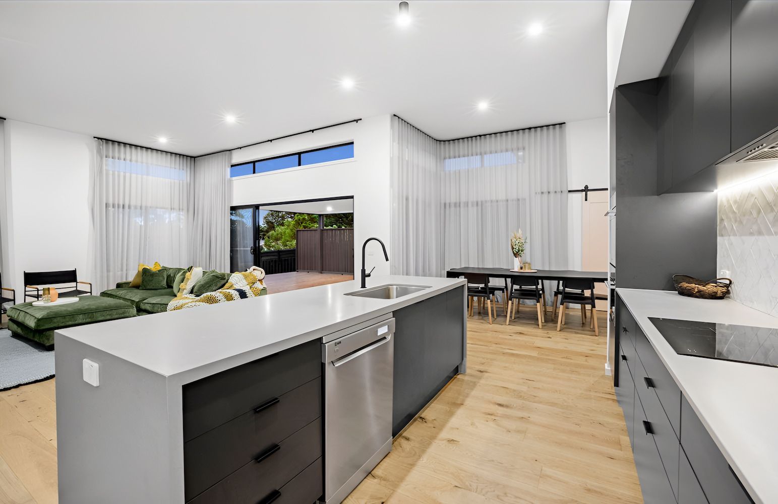 Modern Kitchen With Island, Adjacent Dining Area and Living Room — Kolora Projects in Robina, QLD