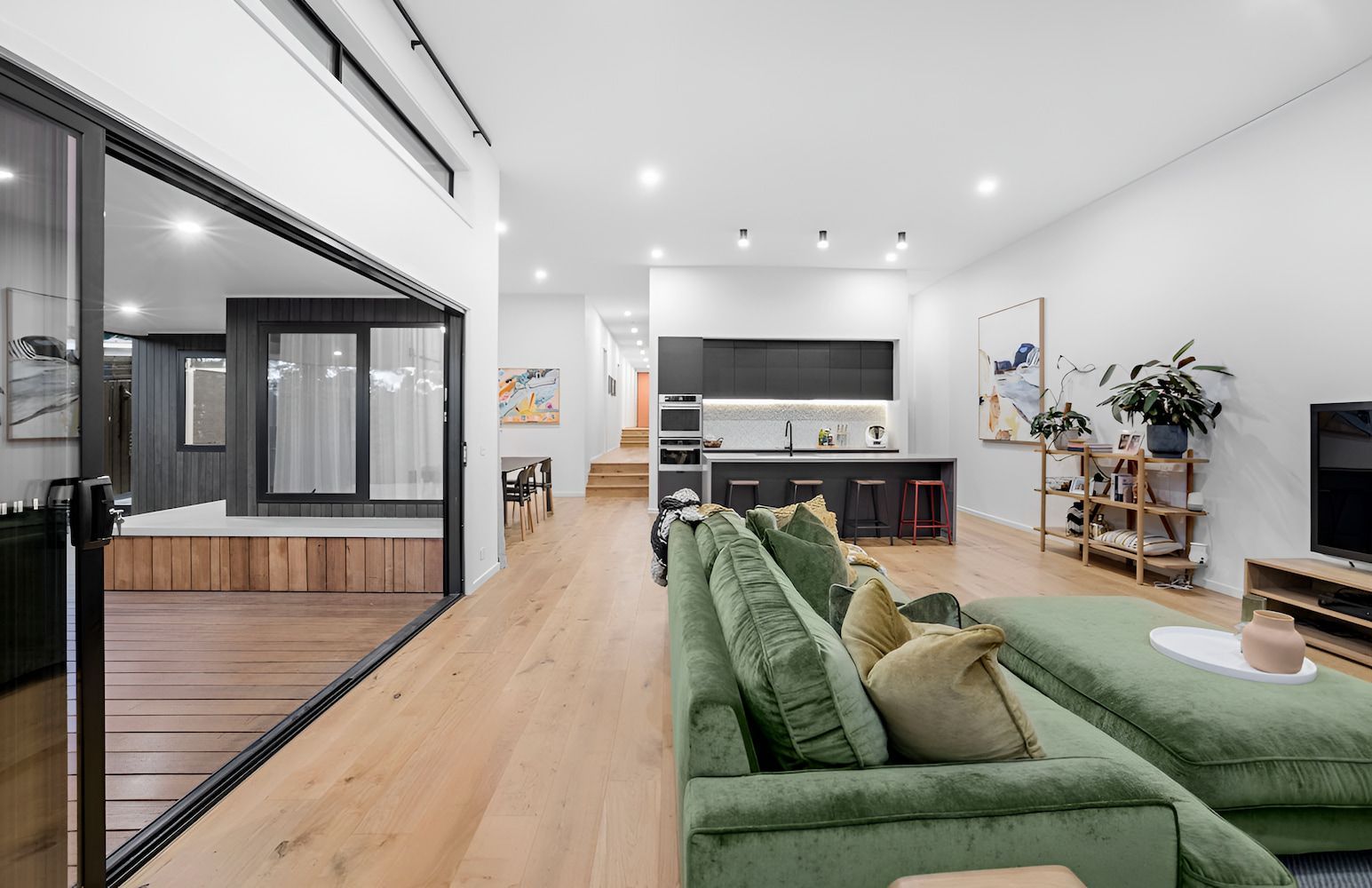 Spacious Modern Living Room With Green Sofa — Kolora Projects in Robina, QLD