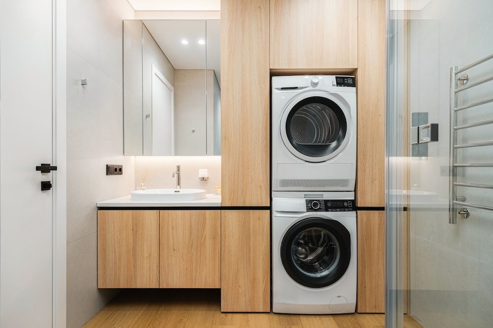 Modern Bathroom With a Stacked Washer and Dryer Unit — Kolora Projects in Palm Beach, QLD