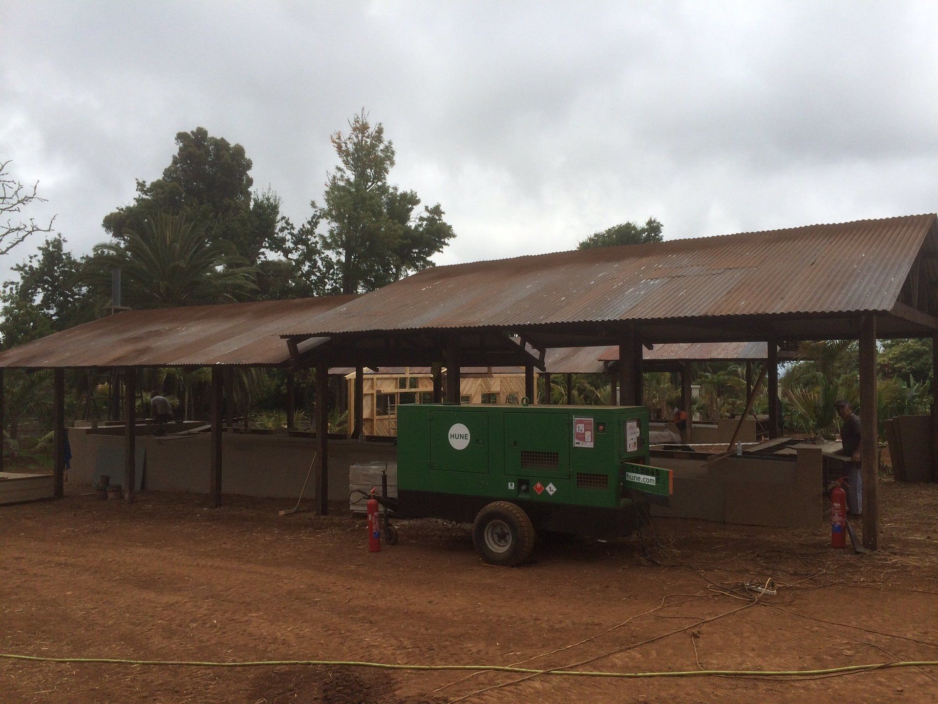 Un remolque verde está estacionado frente a un edificio.