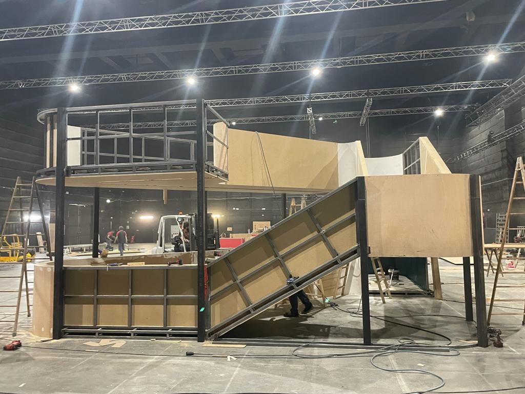 Se está construyendo una gran estructura de madera en una habitación oscura.