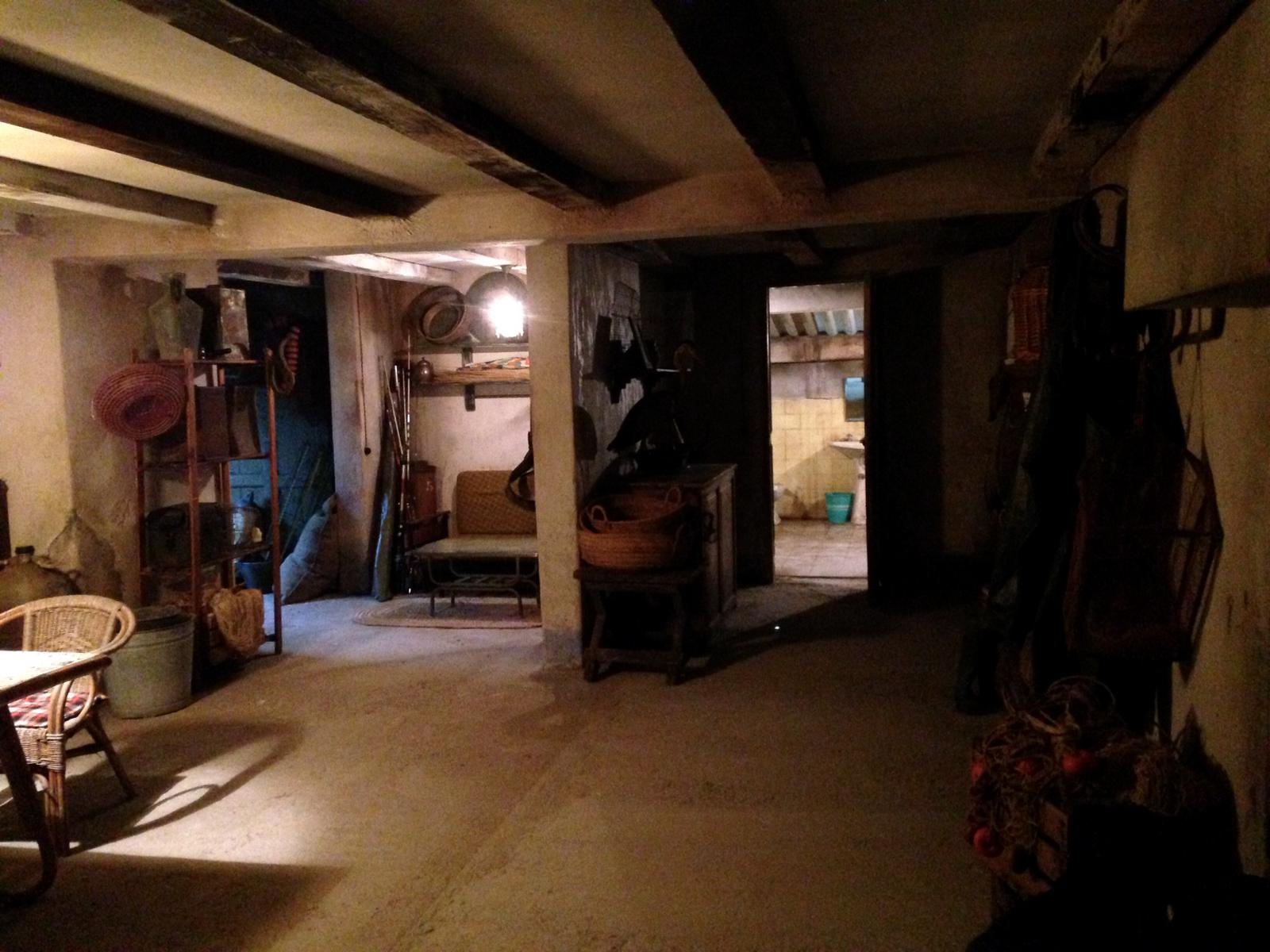 Una habitación oscura con una mesa y sillas.