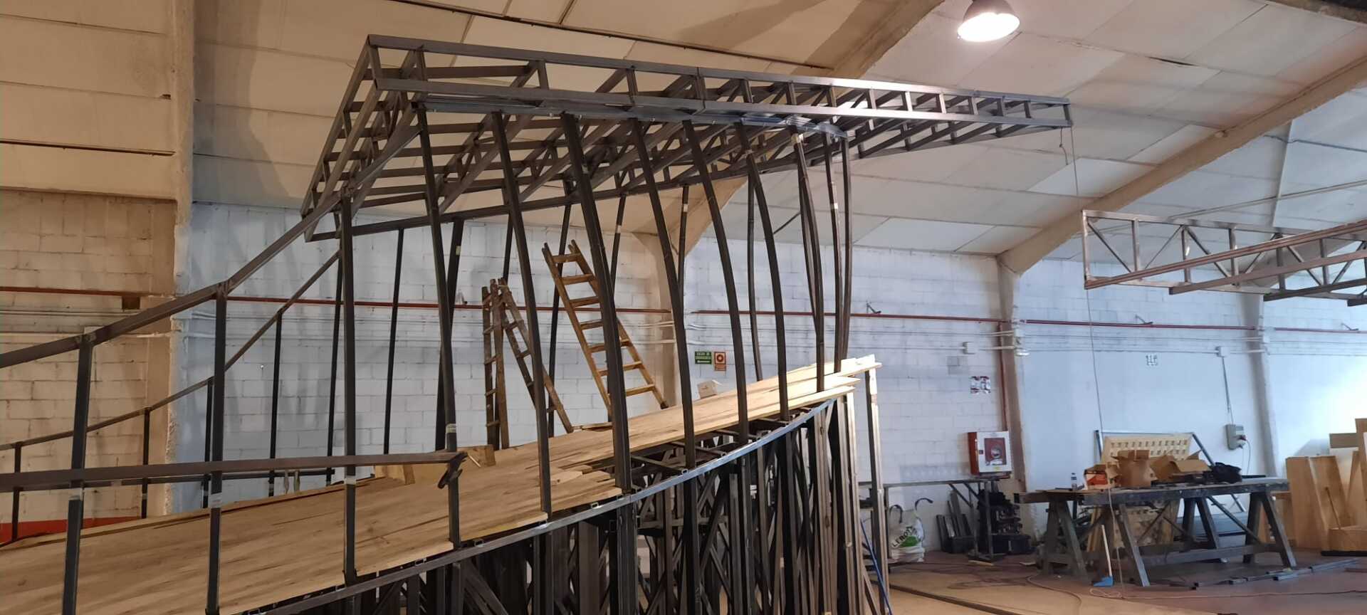 Se está construyendo una gran estructura metálica en un almacén.