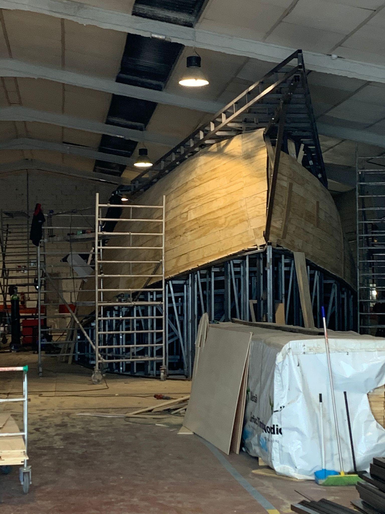 Se está construyendo un gran barco de madera en un almacén.