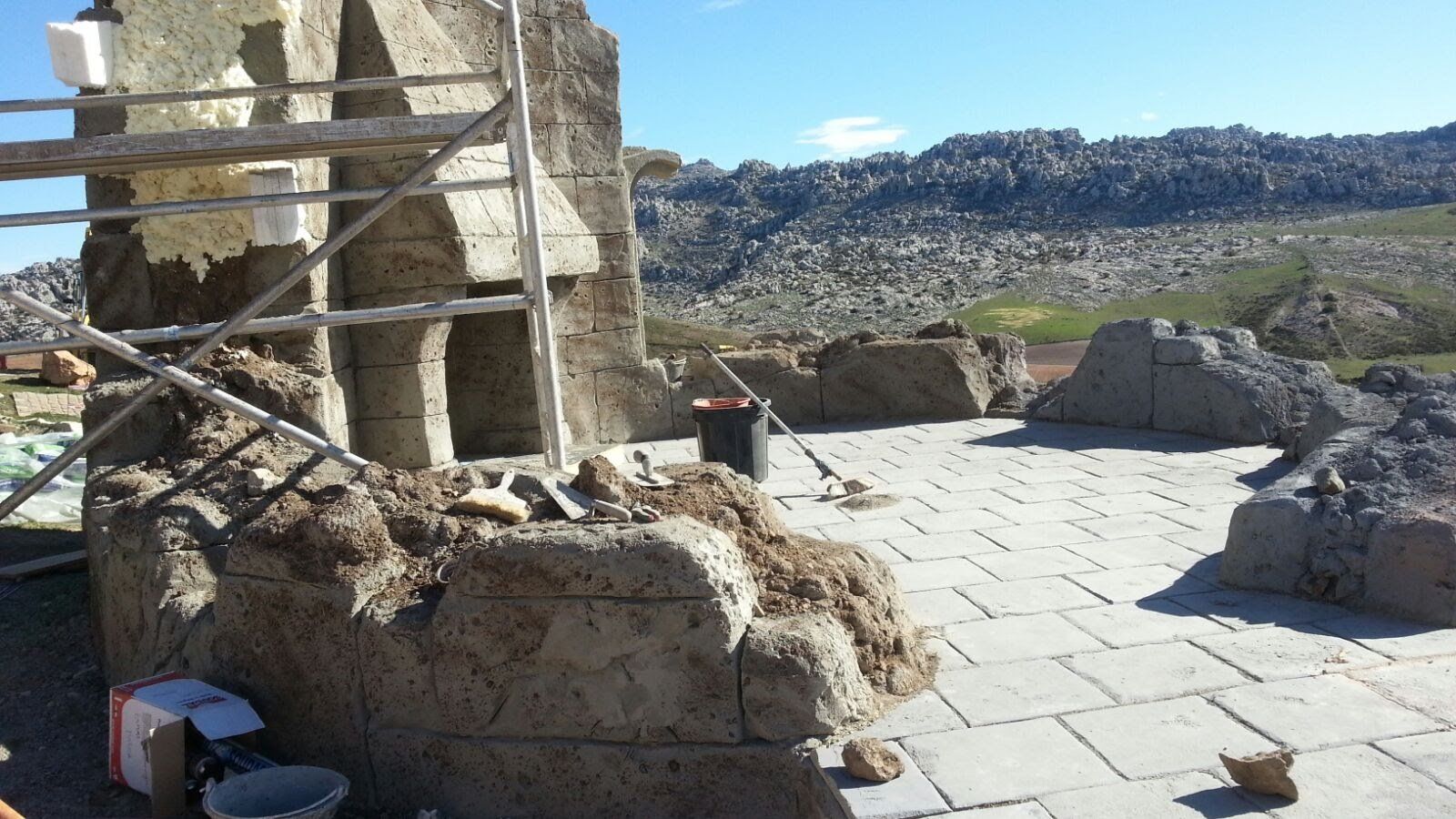 Un gran montón de tierra se encuentra en el suelo frente a una montaña.
