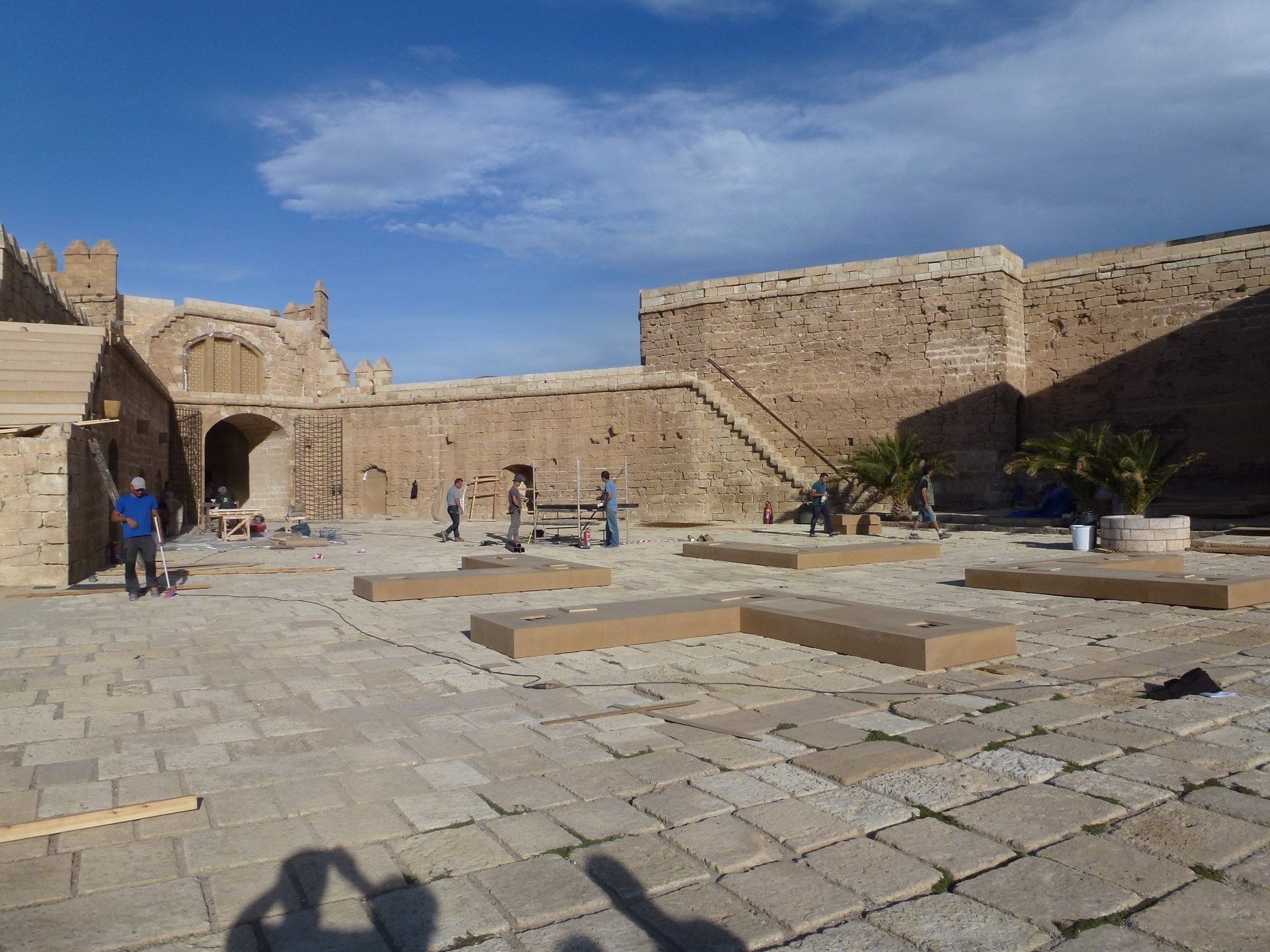 Un hombre con una camisa azul está tomando una foto de un castillo.